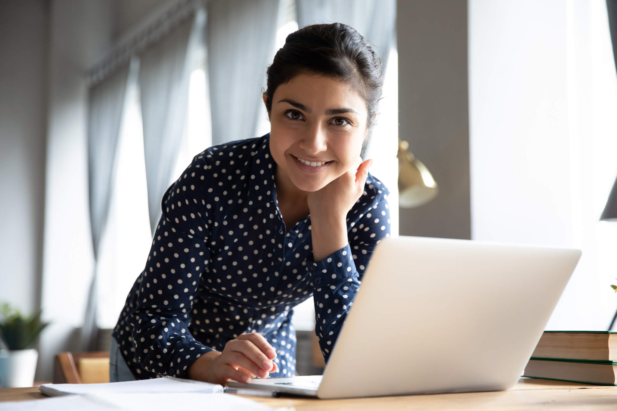 smiling woman working on her computer