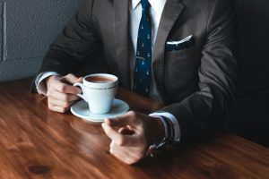 Man negotiating while drinking coffee